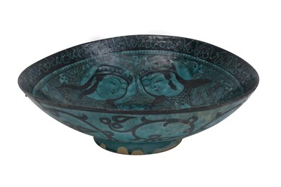 Lot 258 - A BLACK-PAINTED TURQUOISE-GLAZED SELJUK KASHAN-REVIVAL POTTERY DISH WITH COURTLY COUPLE