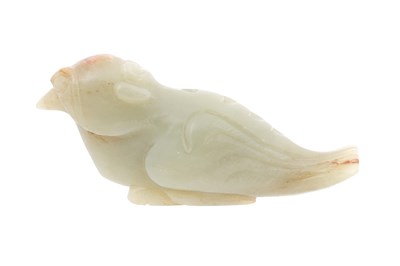 Lot 50 - A CHINESE CELADON JADE ARCHAISTIC CARVING OF A BIRD